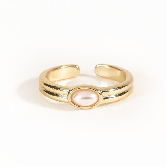 Elegant golden pearl ring with a sleek open-cuff design, ribbed detailing, and adjustable anti-tarnish finish, perfect for timeless styling and everyday elegance.

