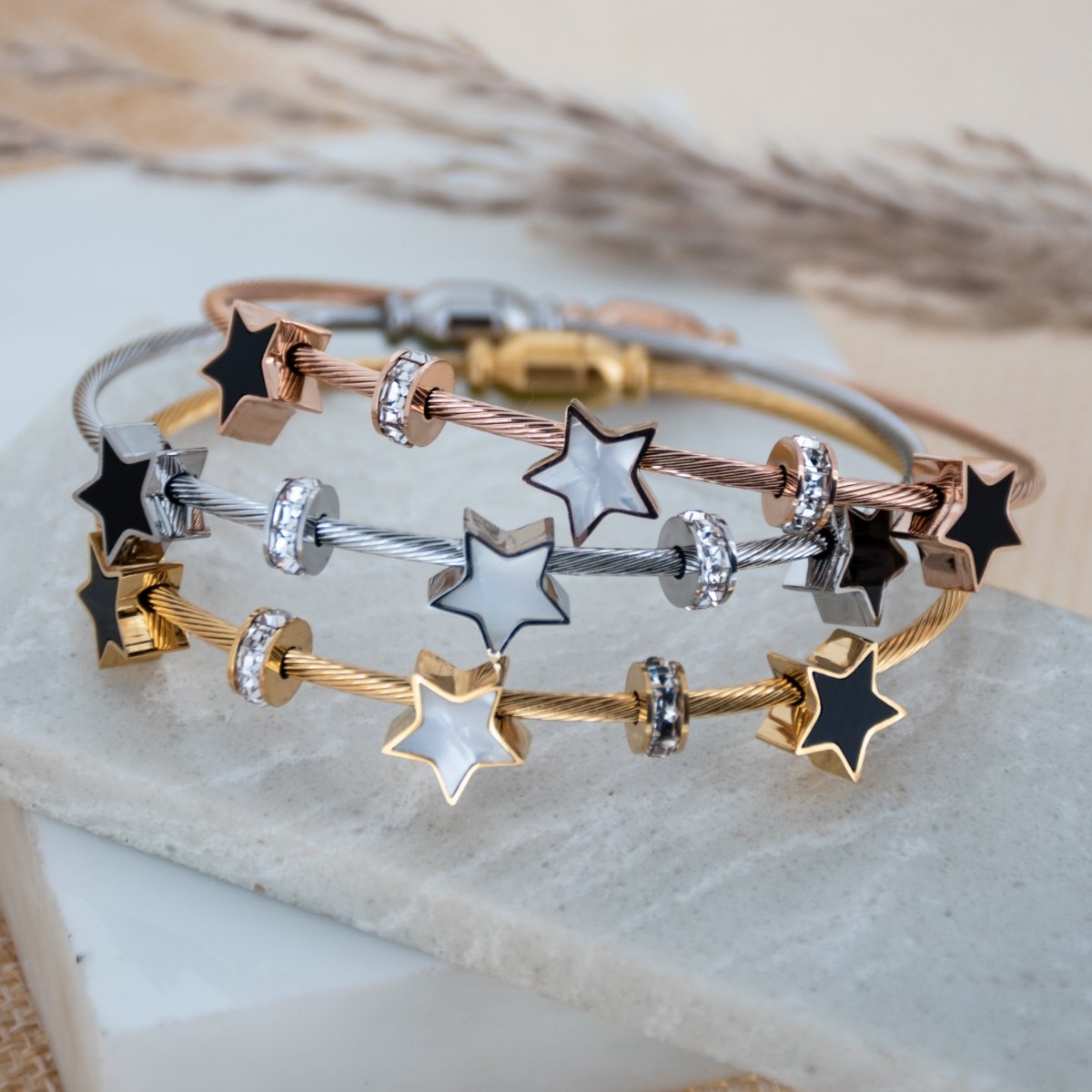 Elegant star bangle with delicate celestial detailing and an anti-tarnish finish, available in rosegold, perfect for everyday wear, youthful styling, and chic minimal looks.
