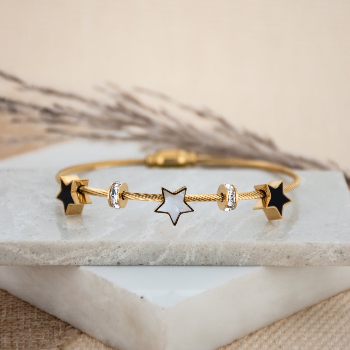 Elegant star bangle with delicate celestial detailing and an anti-tarnish finish, available in rosegold, perfect for everyday wear, youthful styling, and chic minimal looks.