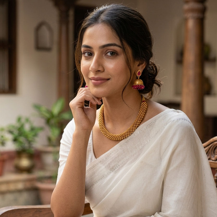 Gold temple bead necklace set with dense collar design and matching jhumka earrings