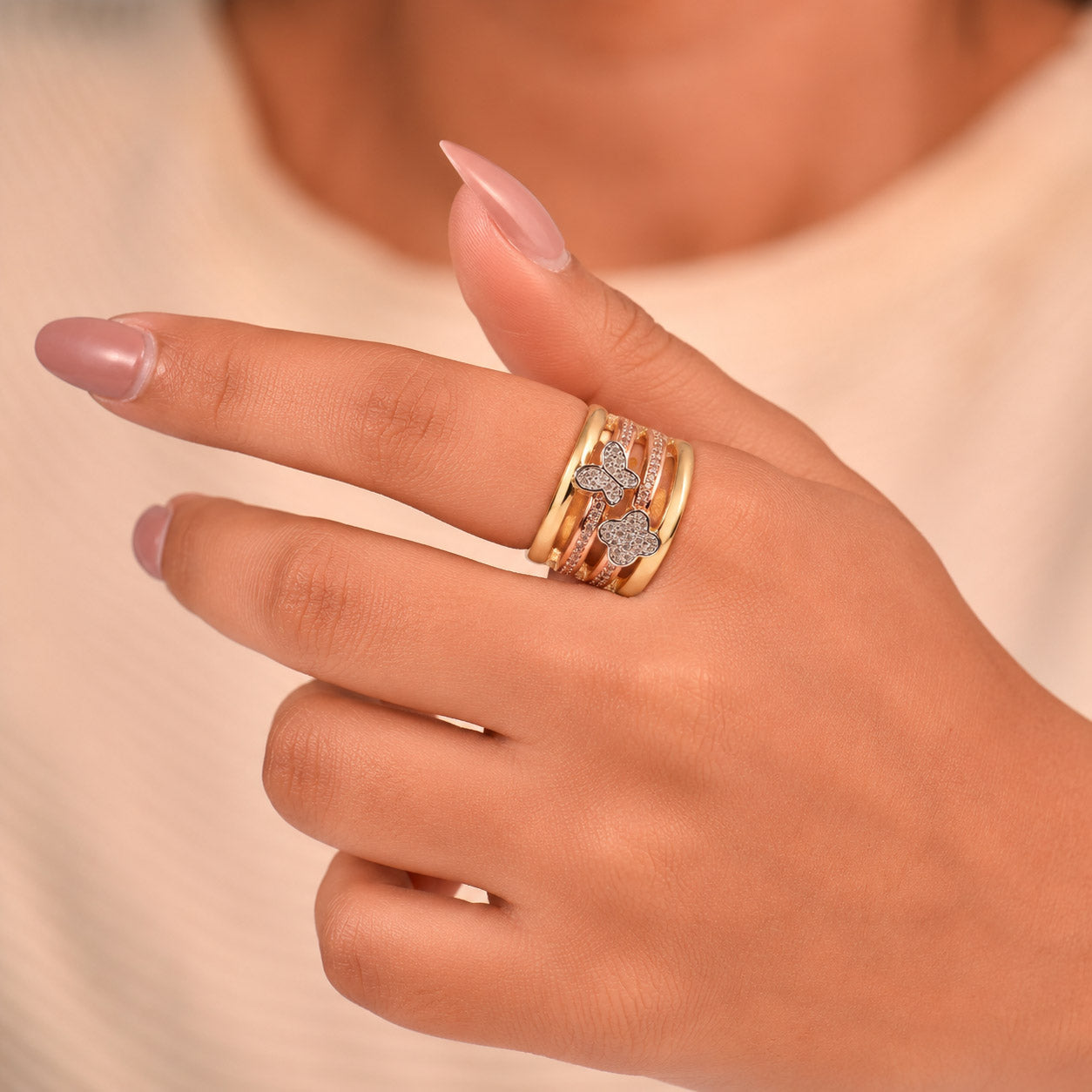 Luxurious golden multi-band ring with sparkling clover and butterfly motifs in an anti-tarnish finish. perfect for statement styling, elegant occasions, and everyday glamour.
