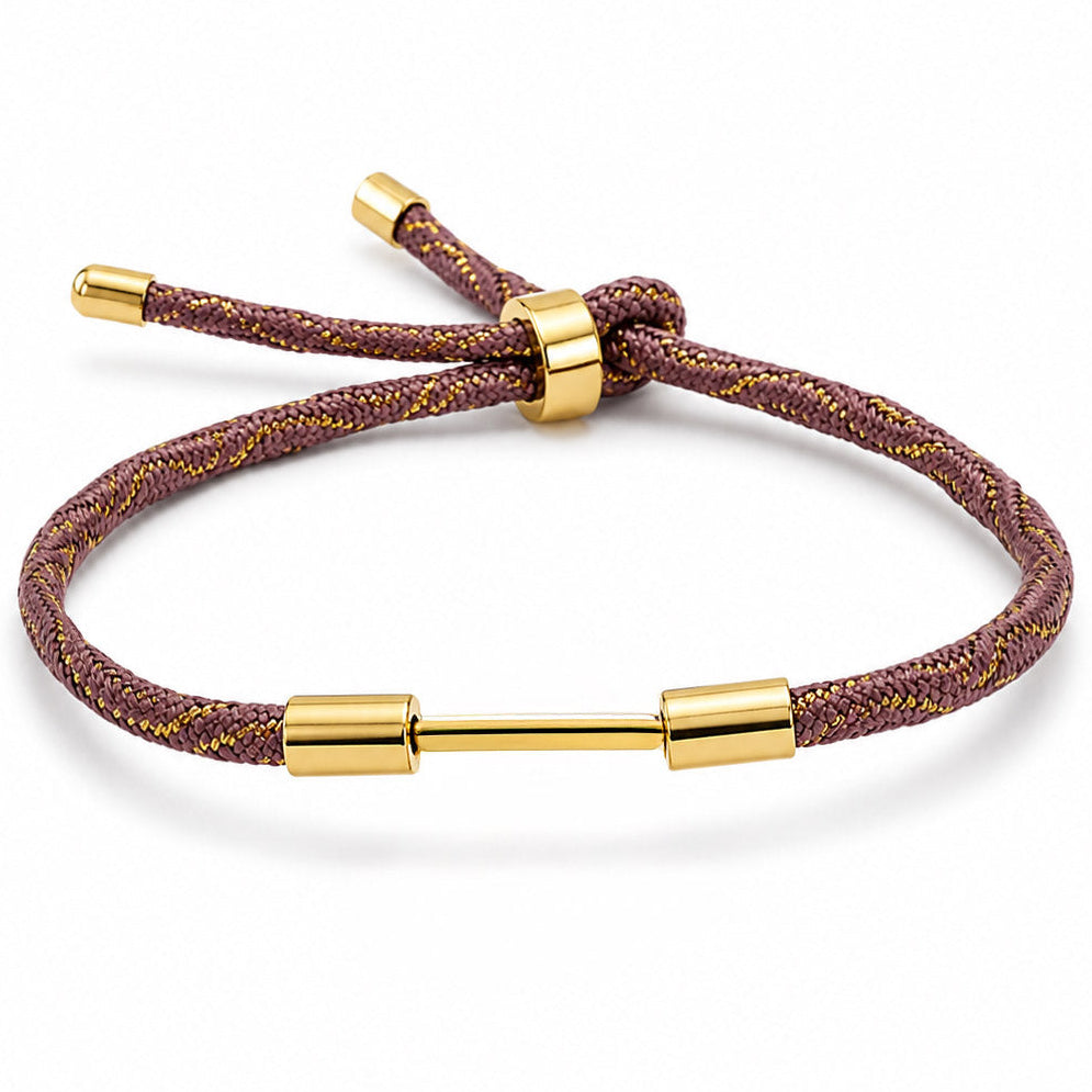 Brown braided cord bracelet with gold lurex weave and a polished gold dumbbell charm.