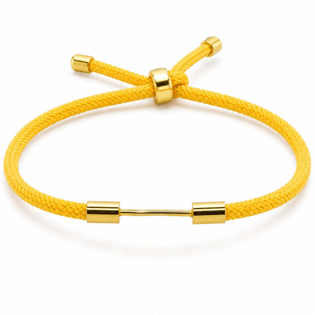 Yellow woven cord bracelet with a polished gold dumbbell charm and adjustable slider bead on a white background.
