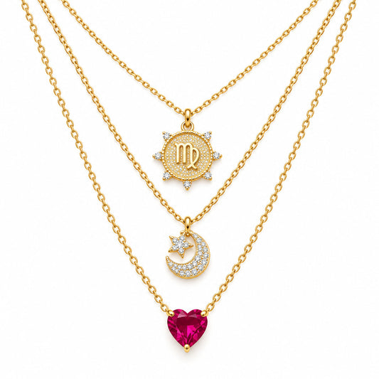 Upakarna gold layered necklace set featuring a Virgo medallion, crystal crescent moon pendant, and pink heart gemstone pendant on a clean white background.