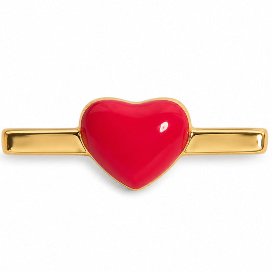 Close-up of a glossy red heart watch charm with polished gold-tone sides on a clean white background.