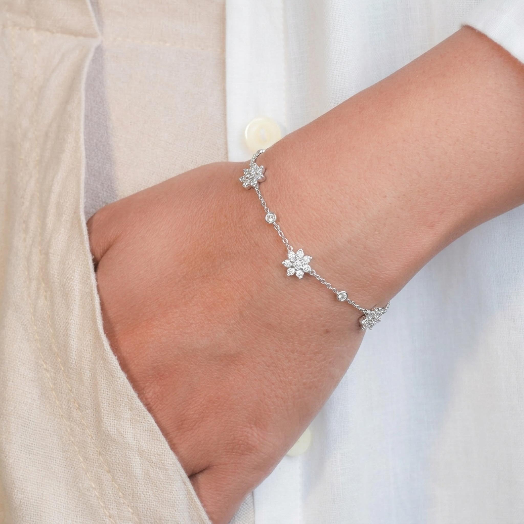 Crystal Blossom 925 Sterling Silver Bracelet featuring a delicate sterling silver chain adorned with three floral motifs encrusted with sparkling cubic zirconia