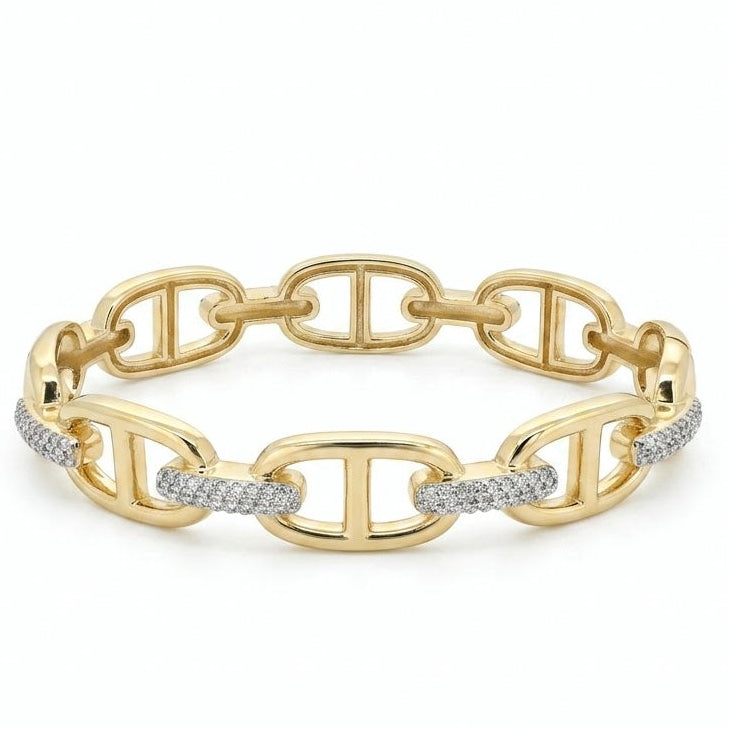 Anti-tarnish yellow gold hinged chain-link bangle bracelet composed of large, polished oval mariner anchor links interconnected by dense pavé-set clear cubic zirconia connector segments, isolated on a solid white background.