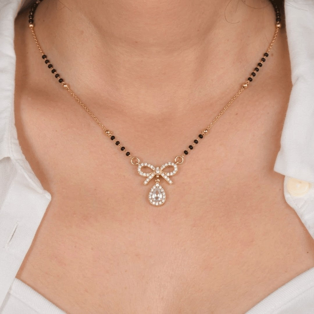 Minimal crystal mangalsutra featuring a delicate bow detail and sparkling teardrop charm