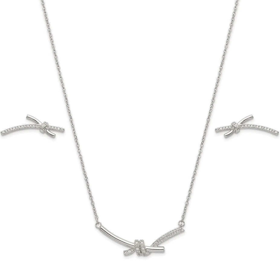 Silver-tone necklace set with a delicate knot design and crystal detailing.
Includes matching stud earrings on a clean white background.