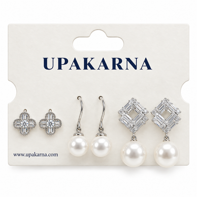 Silver earring set displayed on a white jewellery card, featuring crystal flower studs, pearl drop earrings, and geometric crystal pearl earrings.
