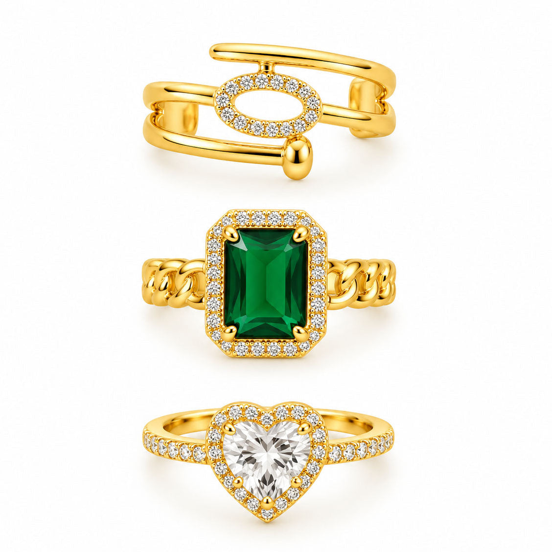 Three gold rings featuring a modern open pavé ring, a bold emerald-cut green gemstone chain ring, and a sparkling heart halo ring on a clean white background.
