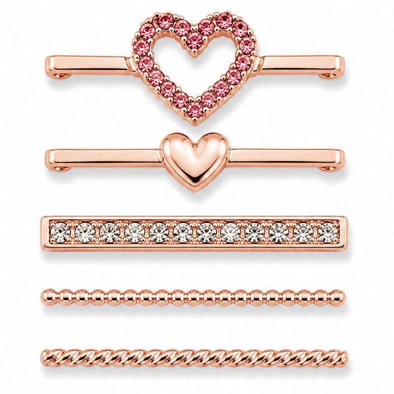 Rose gold-tone watch charms featuring a pink crystal heart outline, polished heart detail, crystal-studded bar, beaded chain design, and twisted chain design, displayed on a white background.