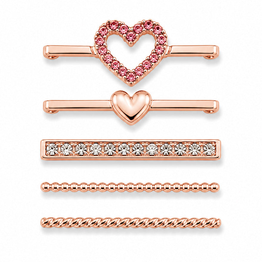 Rose gold-tone watch charms featuring a pink crystal heart outline, polished heart detail, crystal-studded bar, beaded chain design, and twisted chain design, displayed on a white background.