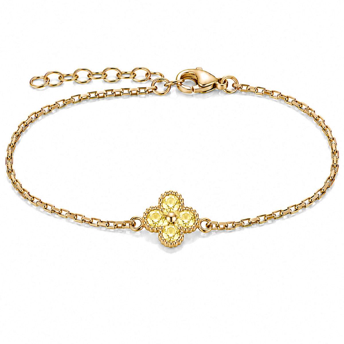 Gold-plated bracelet featuring a delicate four-leaf clover charm with four bright golden-yellow stones, set on a fine gold chain with an adjustable extension chain and lobster clasp, displayed against a clean white background.