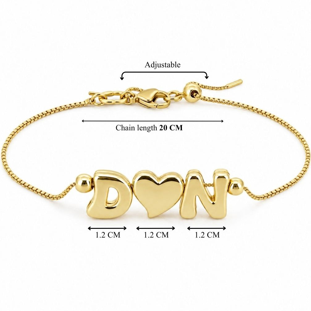 Gold-tone adjustable personalized bracelet featuring D♥N charms, with a 20 cm chain length and approximately 1.2 cm charms.