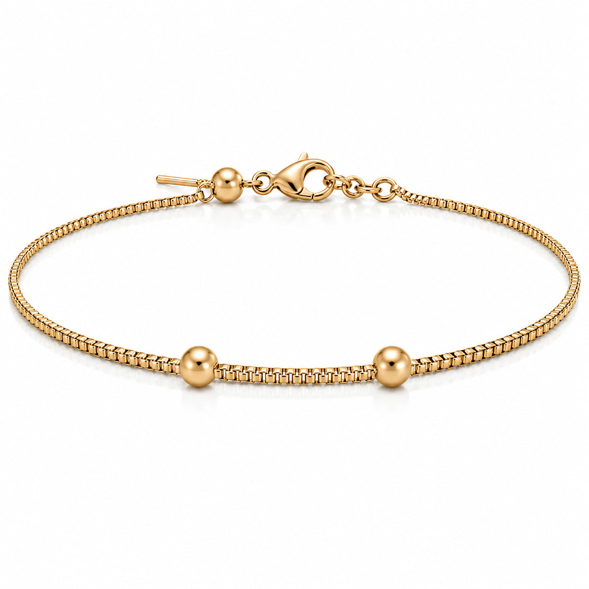 Gold-plated delicate bracelet with a fine chain and two polished gold bead accents, displayed on a clean white background.