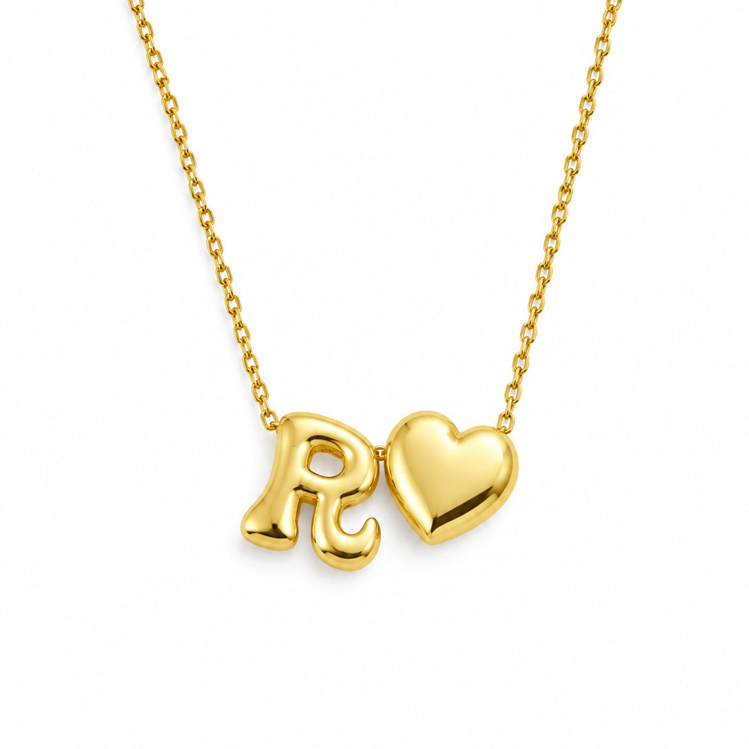 Gold-plated delicate chain necklace featuring a polished R♥ initial-and-heart pendant, displayed on a clean white background.