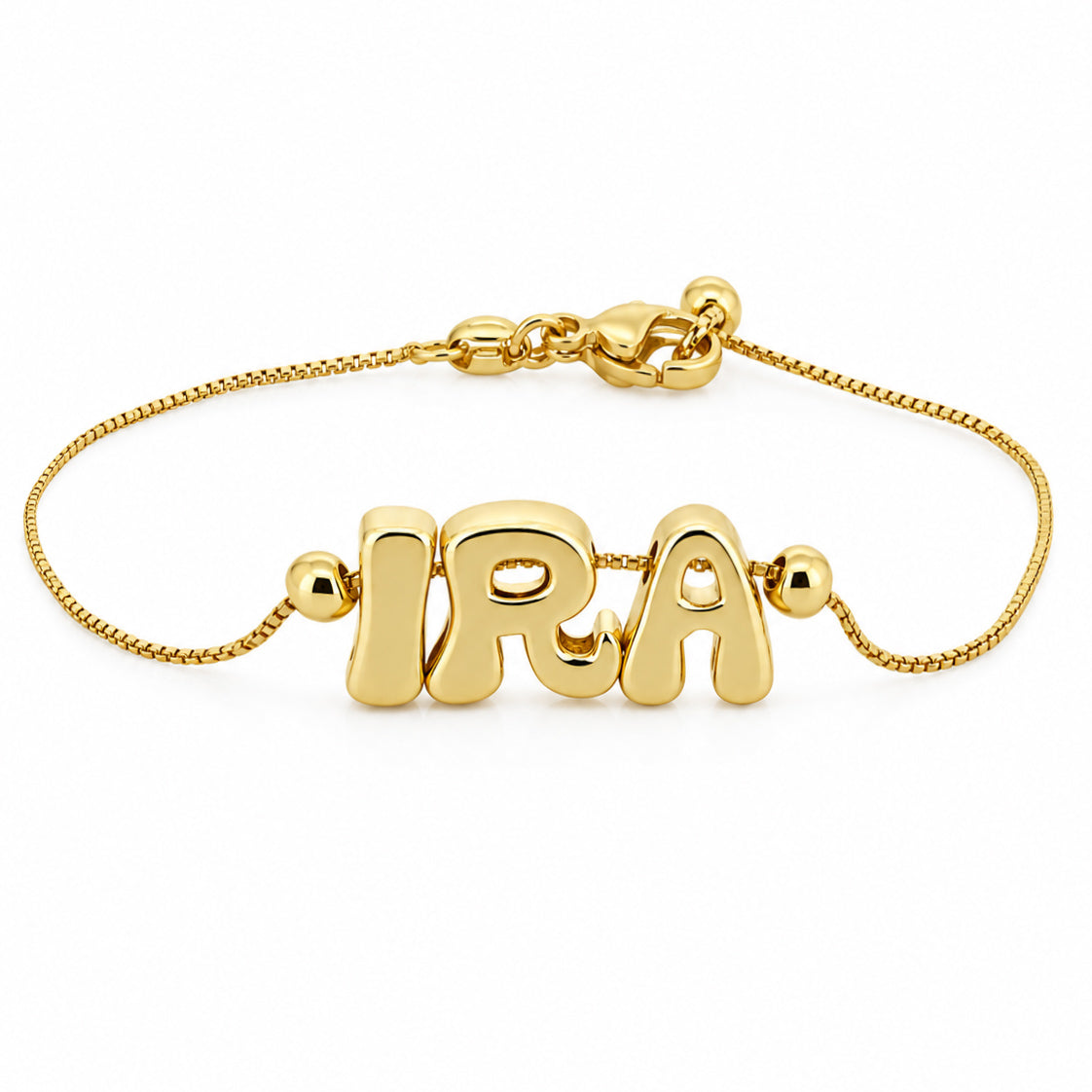 Gold-plated personalized bracelet featuring the name “IRA” on a delicate chain, with round bead accents and a lobster clasp, displayed on a clean white background.