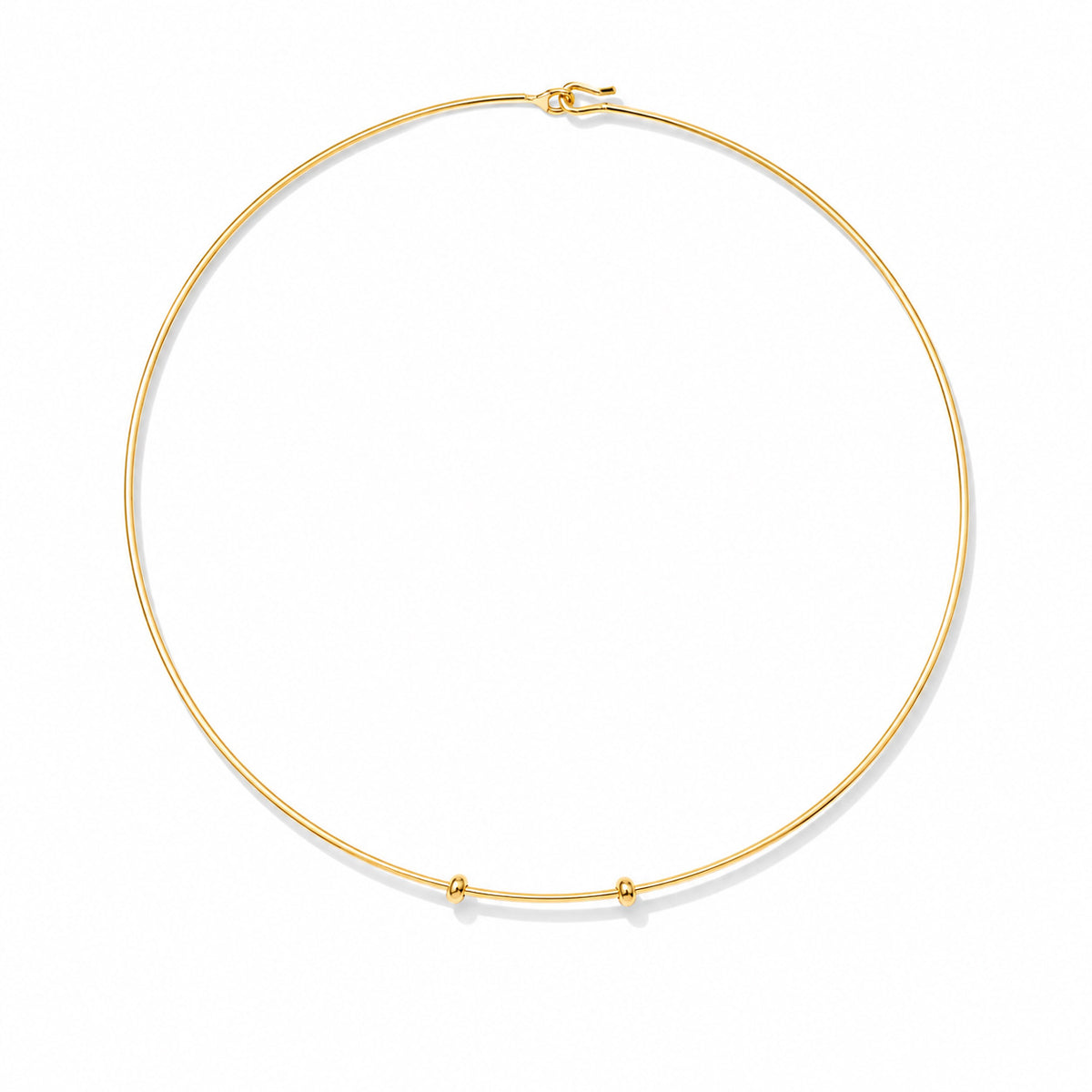 Minimal gold wire necklace on a clean white background, featuring a sleek circular design with small charm holders for customising with personalised charms.