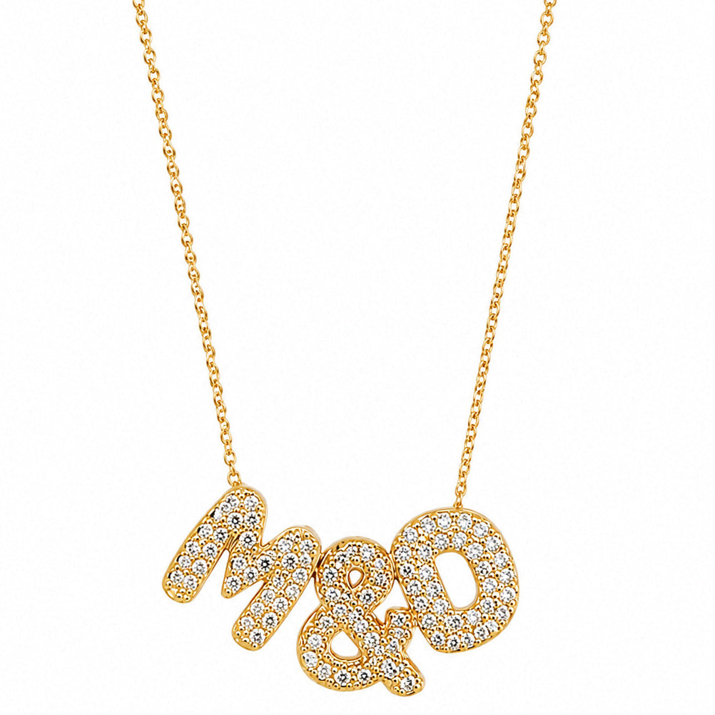 Gold-plated personalized necklace featuring the sparkling pavé initials “M & D” on a delicate chain, displayed on a clean white background.