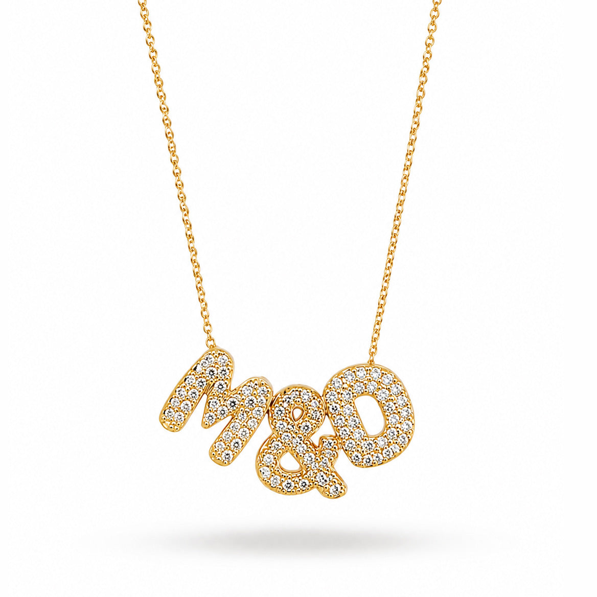 Gold-plated personalized necklace featuring the sparkling pavé initials “M & D” on a delicate chain, displayed on a clean white background.