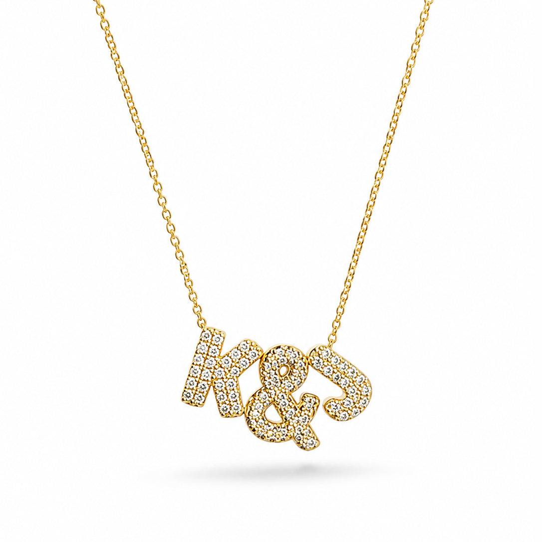 Gold-plated personalized necklace featuring sparkling pavé initials “K & J” on a delicate chain, displayed on a clean white background.