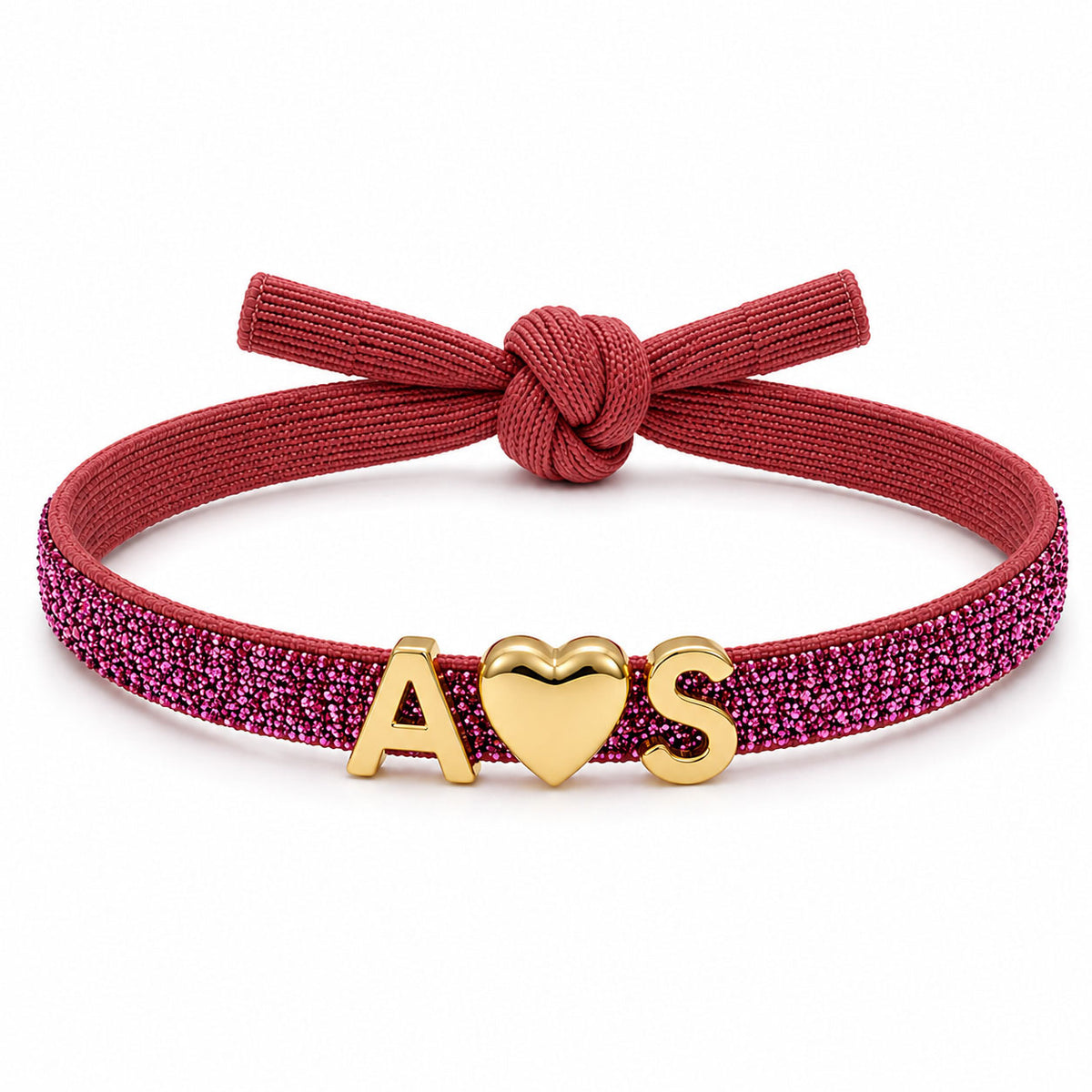 Pink glitter bracelet with a matching deep pink fabric knot, featuring gold A♥S charms on a clean white background.