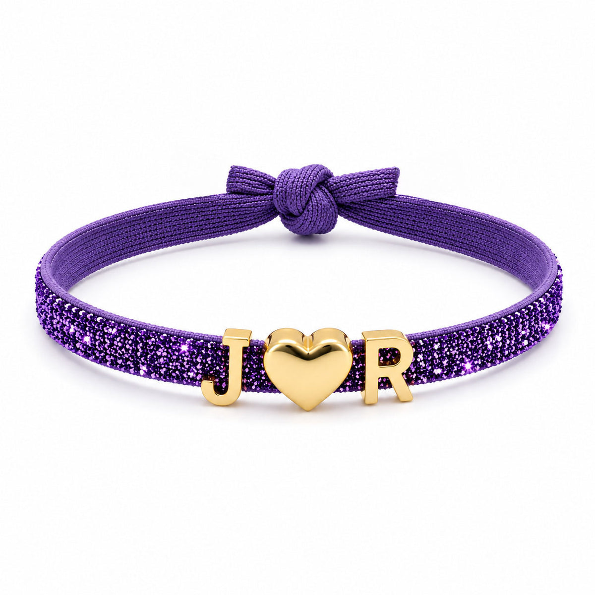 Purple glitter bracelet featuring a gold J♥R charm combination and a matching purple fabric knot, displayed on a clean white background.