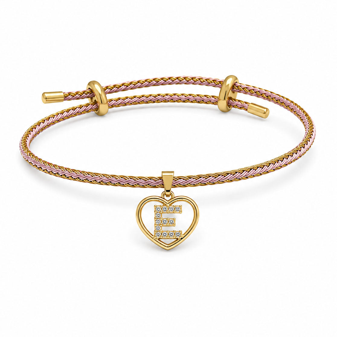 Brown braided adjustable bracelet on a clean white background, featuring a gold heart-shaped pendant with a sparkling letter E initial charm.