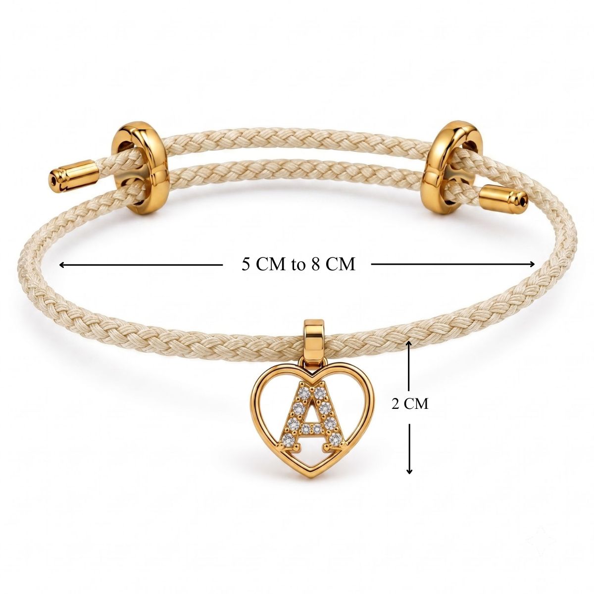 Cream braided bracelet with gold-tone fittings and a heart-shaped initial “A” charm embellished with clear crystals, shown with adjustable 5–8 cm sizing and a 2 cm charm measurement on a white background.