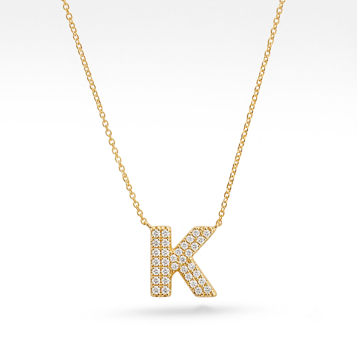 Gold-plated personalized K initial necklace featuring a sparkling pavé letter K on a delicate gold chain, displayed against a clean white background.