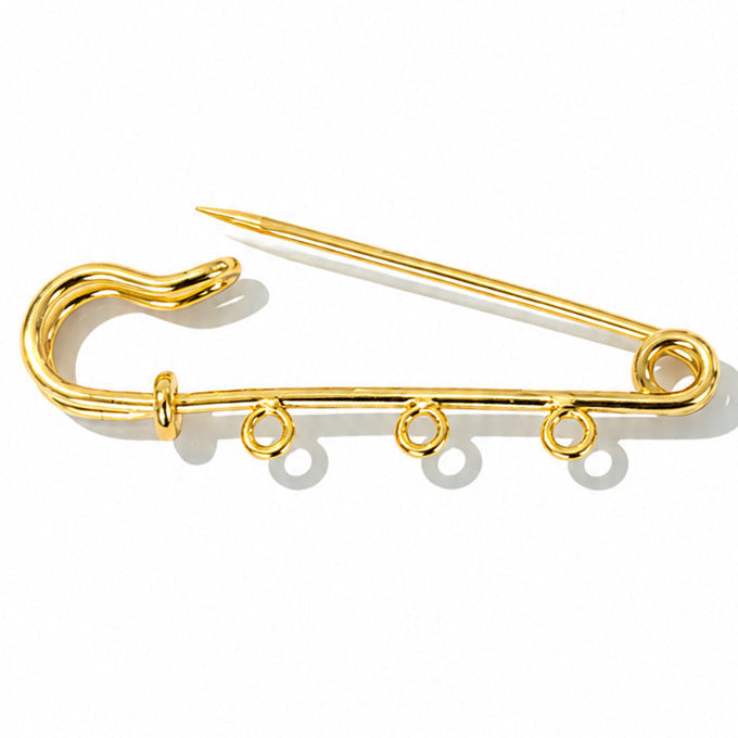 Gold-tone open safety pin charm holder with three attachment loops, displayed on a clean white background.