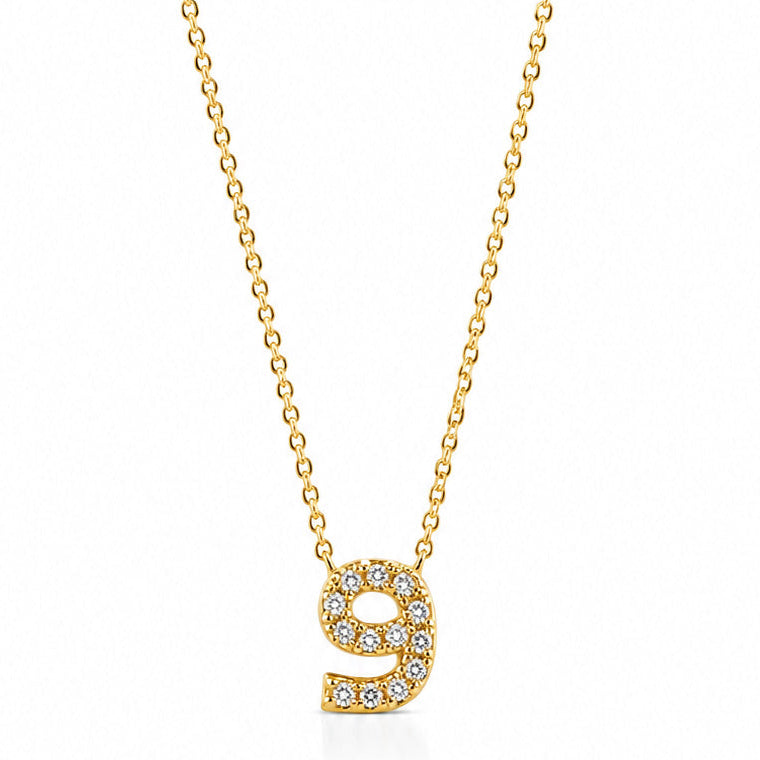 Gold-plated personalized number necklace featuring a sparkling pavé “9” pendant on a delicate gold chain, displayed against a clean white background.