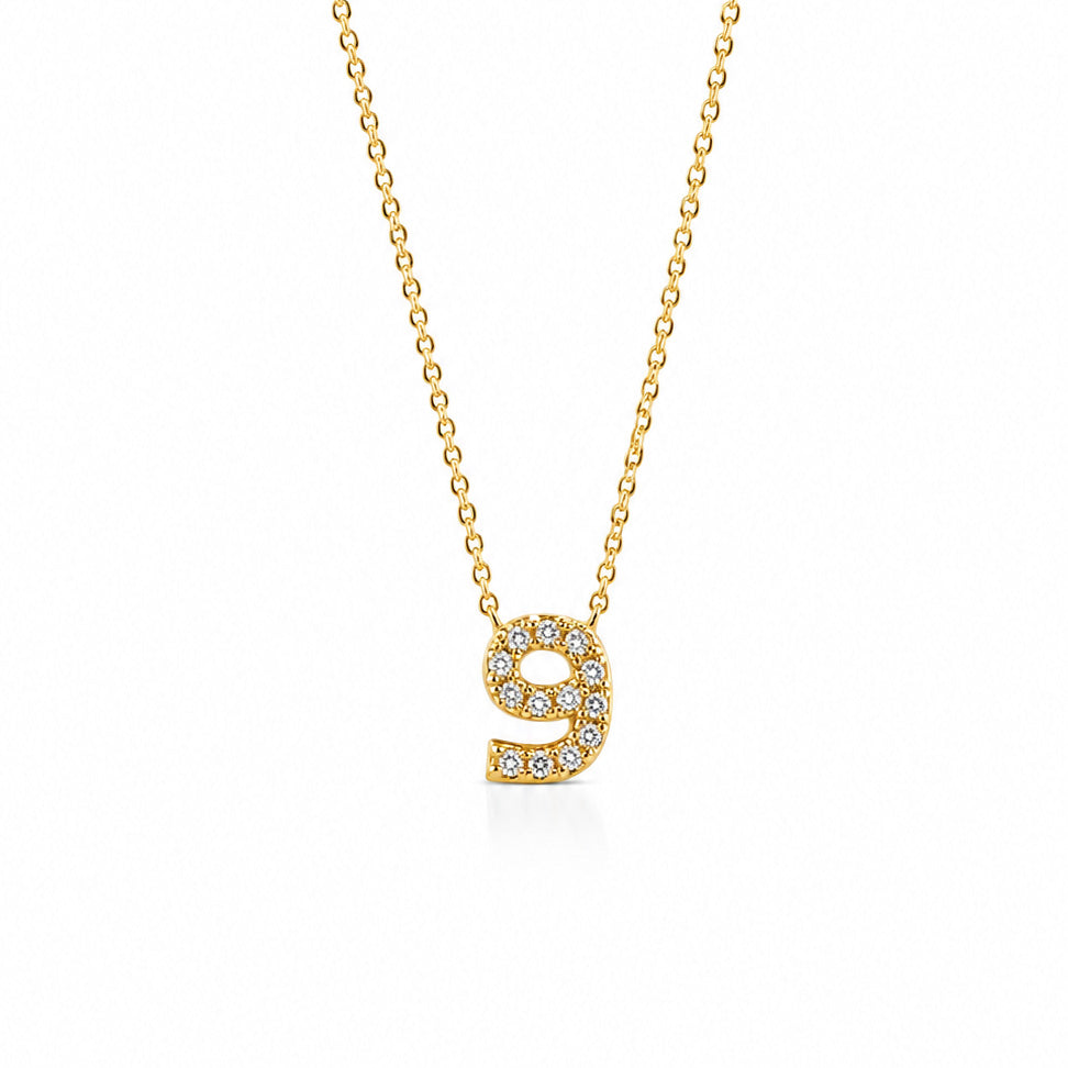 Gold-plated personalized number necklace featuring a sparkling pavé “9” pendant on a delicate gold chain, displayed against a clean white background.