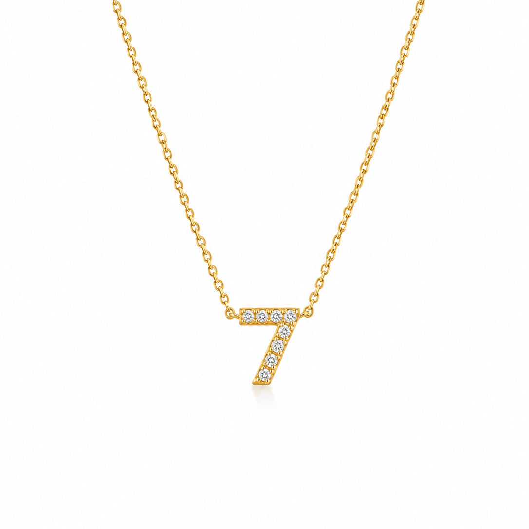 Gold-plated personalized number necklace featuring a sparkling pavé “7” pendant on a delicate gold chain, displayed against a clean white background.