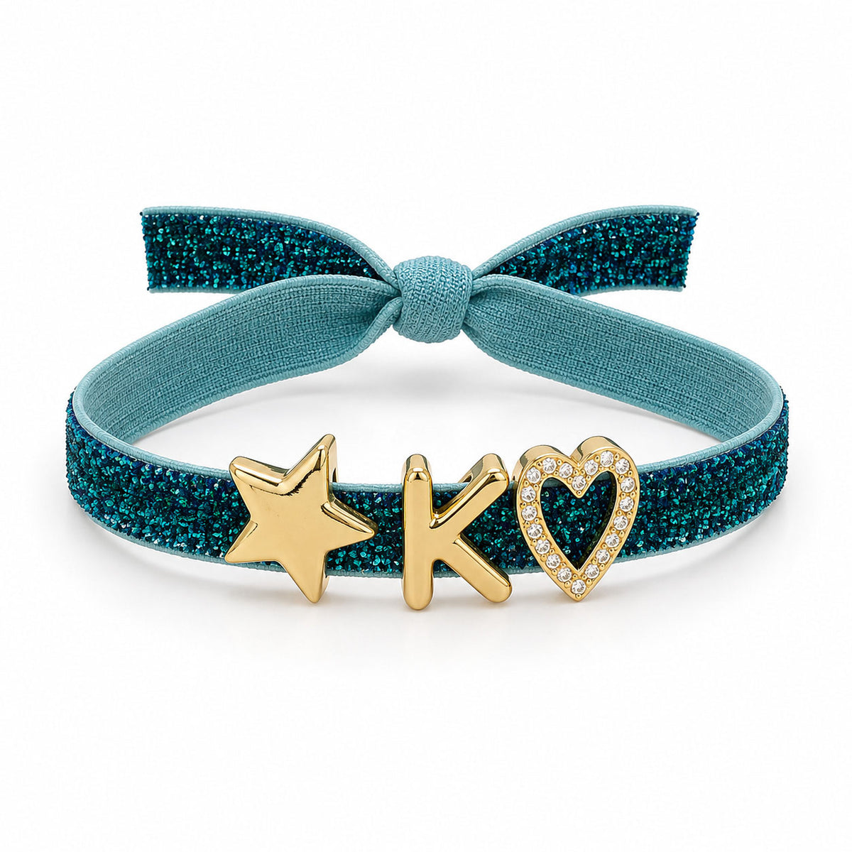Glitter Bracelet with a teal-blue glitter band, matching fabric bow, and gold star, initial “K,” and crystal heart charms on a clean white background.