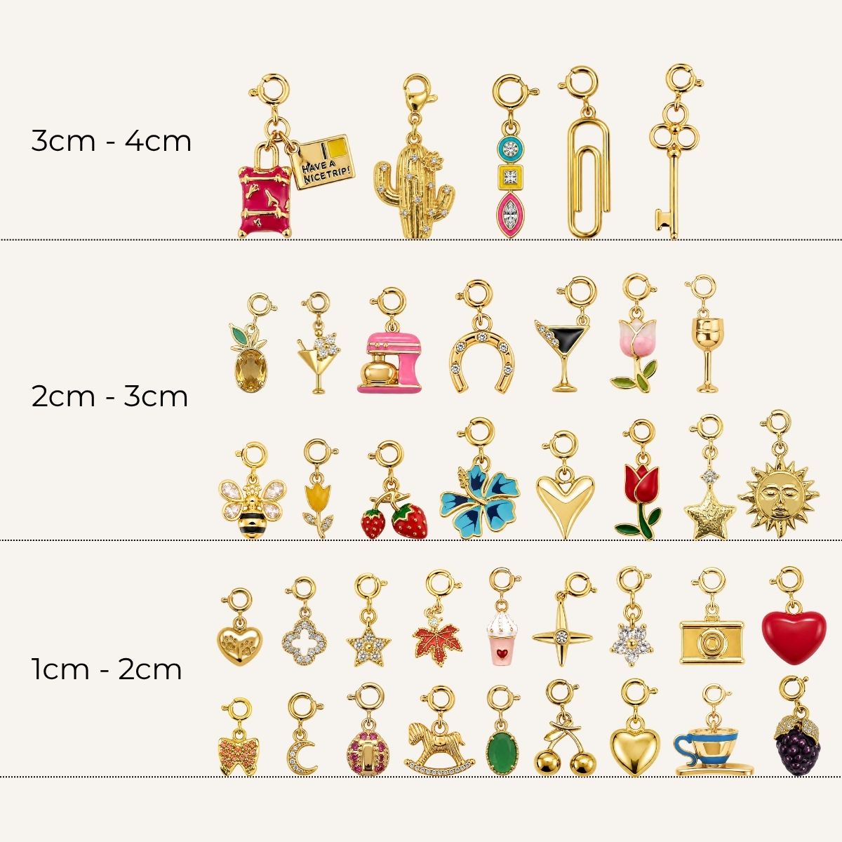 A collection of various gold-toned charms featuring spring-ring clasps, categorized by size ranges from 1 cm to 4 cm. The charms include diverse designs such as travel items, food and drink, animals, flowers, celestial shapes, and everyday objects with colorful enamel and crystal details.   