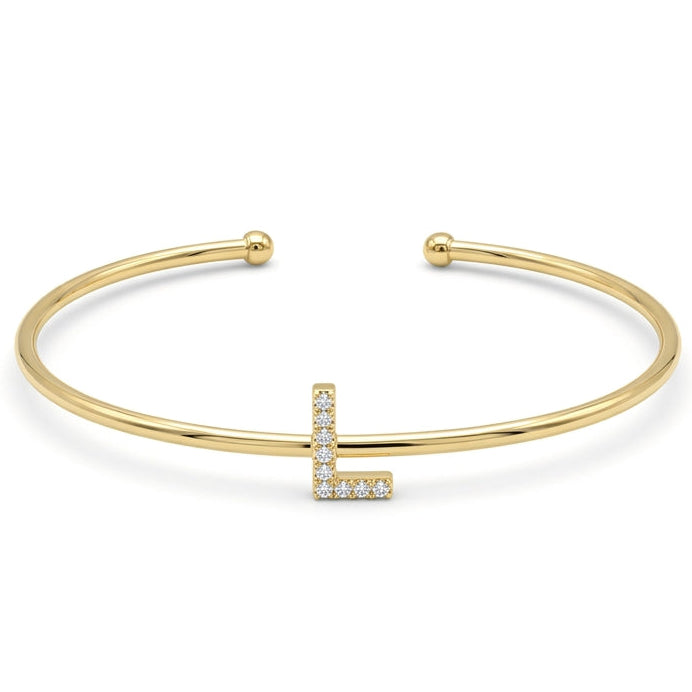 Elegant gold-tone adjustable open cuff bangle featuring a pavé crystal-studded letter L centerpiece. The personalized initial bangle has a sleek polished finish with rounded ball ends and is displayed on a clean white background, making it perfect for everyday wear, stacking, gifting, and personalized jewellery collections.
