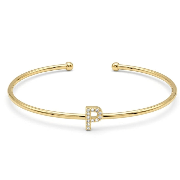 Elegant gold-tone adjustable open cuff bangle featuring a pavé crystal-studded letter P centerpiece. The personalized initial bangle has a sleek polished finish with rounded ball ends and is displayed on a clean white background, making it perfect for everyday wear, stacking, gifting, and personalized jewellery collections.