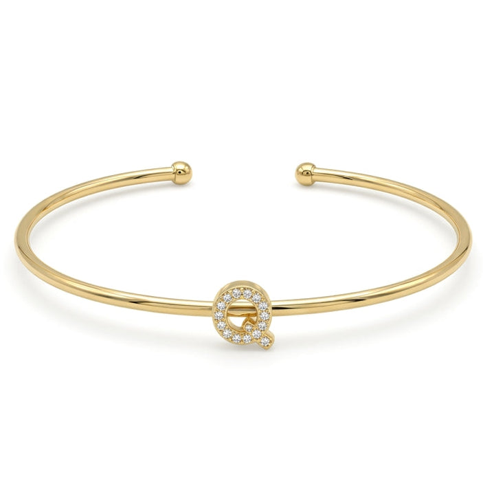 Elegant gold-tone adjustable open cuff bangle featuring a pavé crystal-studded letter Q centerpiece. The personalized initial bangle has a sleek polished finish with rounded ball ends and is displayed on a clean white background, making it perfect for everyday wear, stacking, gifting, and personalized jewellery collections.