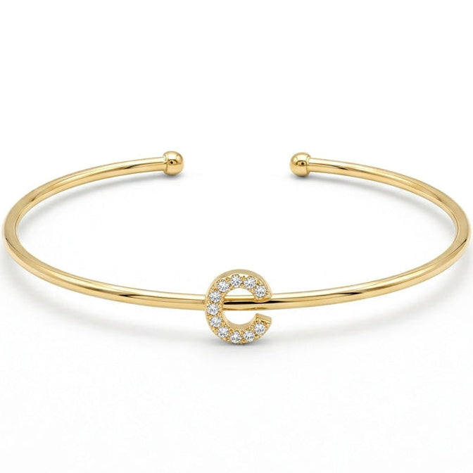 Elegant gold-tone adjustable open cuff bangle featuring a pavé crystal-studded letter C centerpiece. The personalized initial bangle has a sleek polished finish with rounded ball ends and is displayed on a clean white background, making it perfect for everyday wear, stacking, gifting, and personalized jewellery collections.