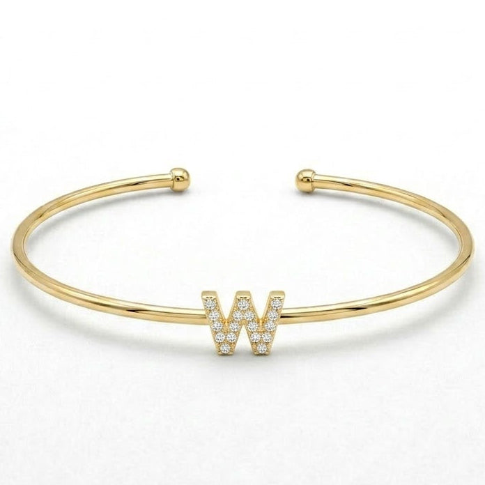 Elegant gold-tone adjustable open cuff bangle featuring a pavé crystal-studded letter W centerpiece. The personalized initial bangle has a sleek polished finish with rounded ball ends and is displayed on a clean white background, making it perfect for everyday wear, stacking, gifting, and personalized jewellery collections.