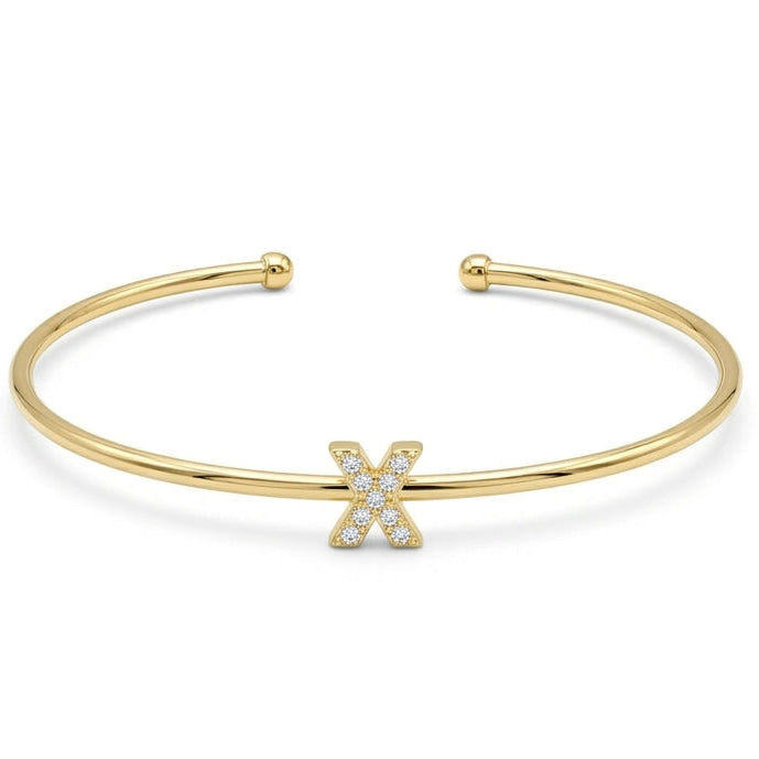 Elegant gold-tone adjustable open cuff bangle featuring a pavé crystal-studded letter X centerpiece. The personalized initial bangle has a sleek polished finish with rounded ball ends and is displayed on a clean white background, making it perfect for everyday wear, stacking, gifting, and personalized jewellery collections.