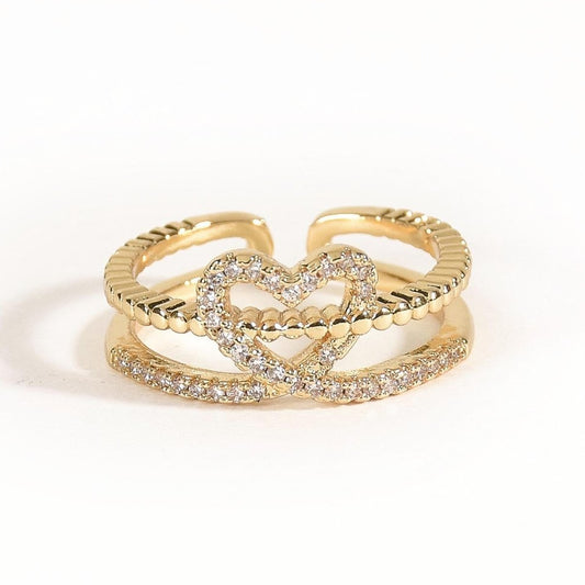 Elegant golden heart ring with twin-band detailing, sparkling pavé accents, and an adjustable anti-tarnish finish, perfect for soft glam styling, everyday elegance, and thoughtful gifting.