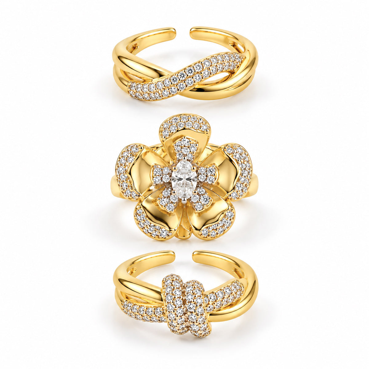 A set of three polished gold-toned rings displayed vertically together as a coordinated stack.