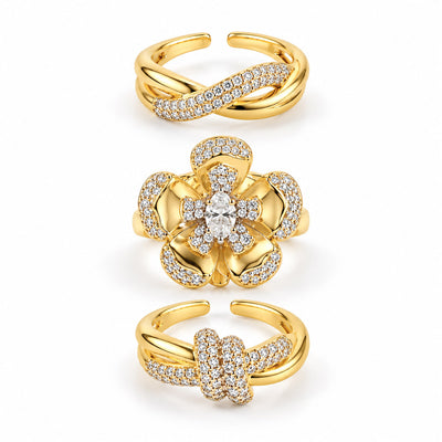 A set of three polished gold-toned rings displayed vertically together as a coordinated stack.