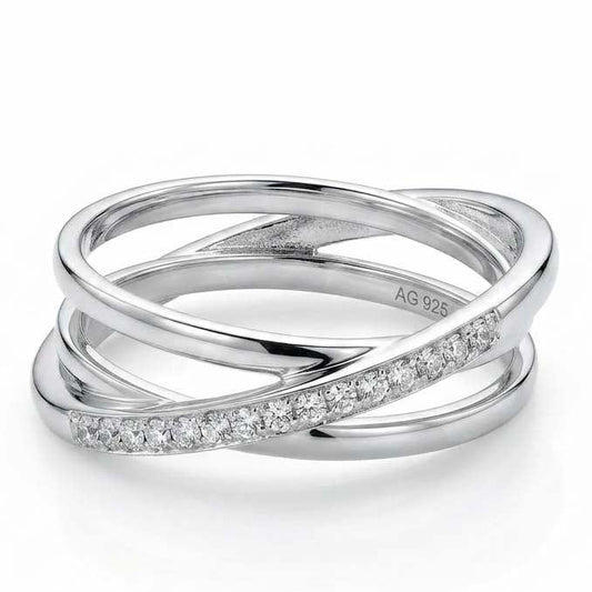 Silver crossover ring featuring intertwined bands with pave-set crystals in a modern layered design, displayed on a white background