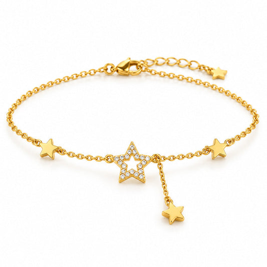Gold-tone adjustable star anklet featuring a sparkling crystal-studded open star centerpiece, two solid gold star charms, and a dangling star pendant on a delicate chain, displayed on a clean white background.