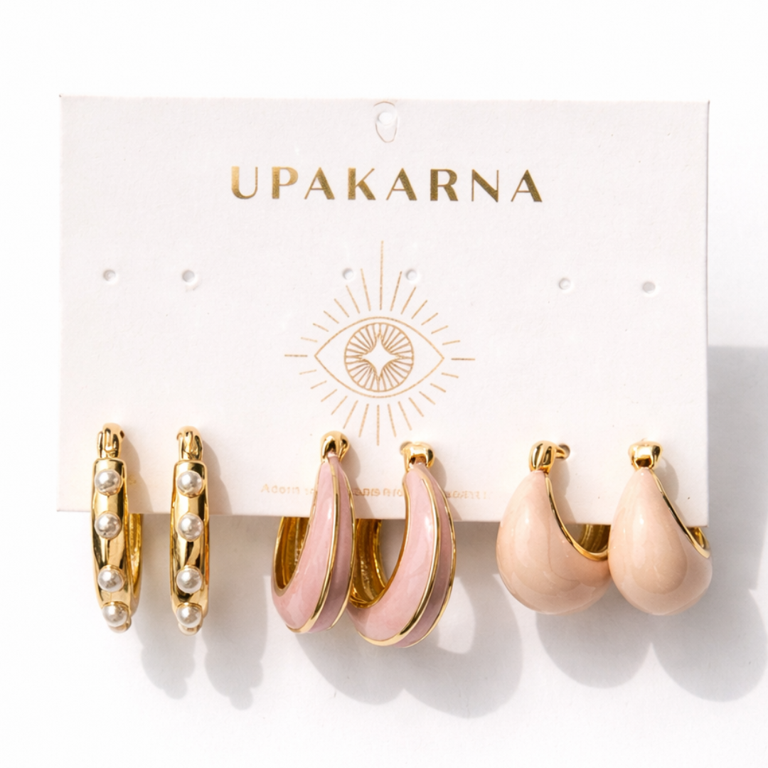 Dreamy pink earring stack with pastel enamel hoops, pearl lined hoops, and soft pink teardrop earrings in gold finish
