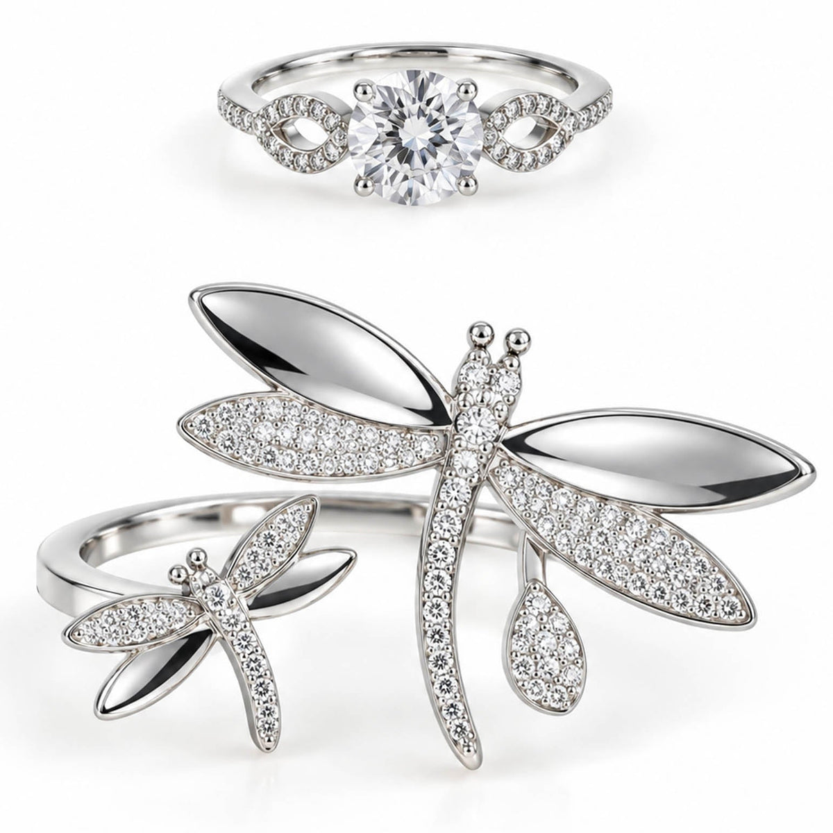 A product photo of two silver-tone rings featuring a solitaire crystal band with infinity-knot shoulders and an open wrap-around ring adorned with large, crystal-paved dragonfly motifs.